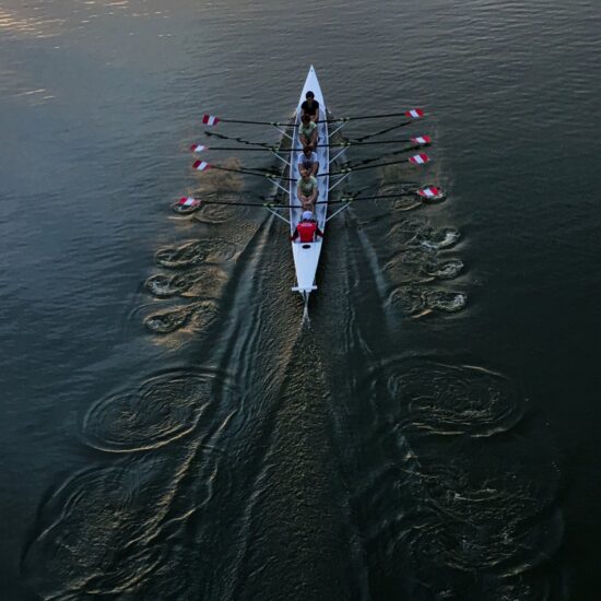 A rowing boat with rowers in it