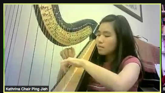 A woman playing the harp.