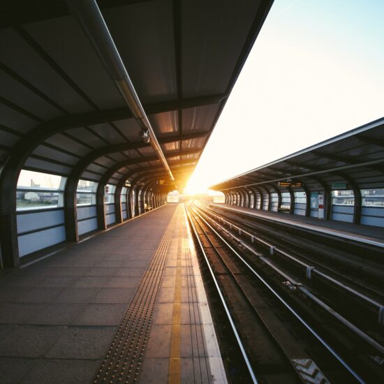 Empty train platofrm with sun rising in the horizon