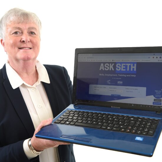 ERSA CEO Elizabeth Taylor holding a laptop
