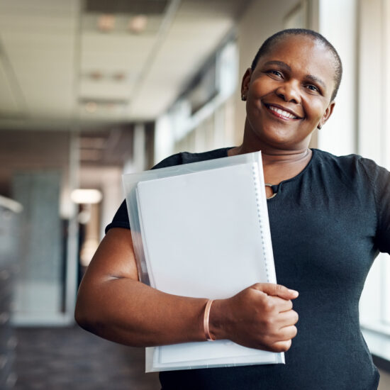 A black woman holding a folder full of papers