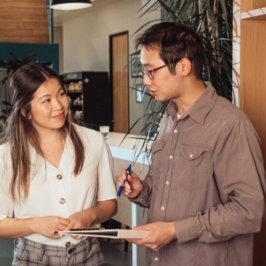 Asian male and female in an office environment