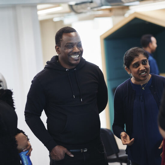 Renaisi team members smiling and chatting together.