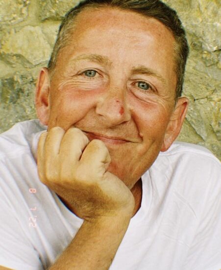 David Brook, posing chin on hand.
